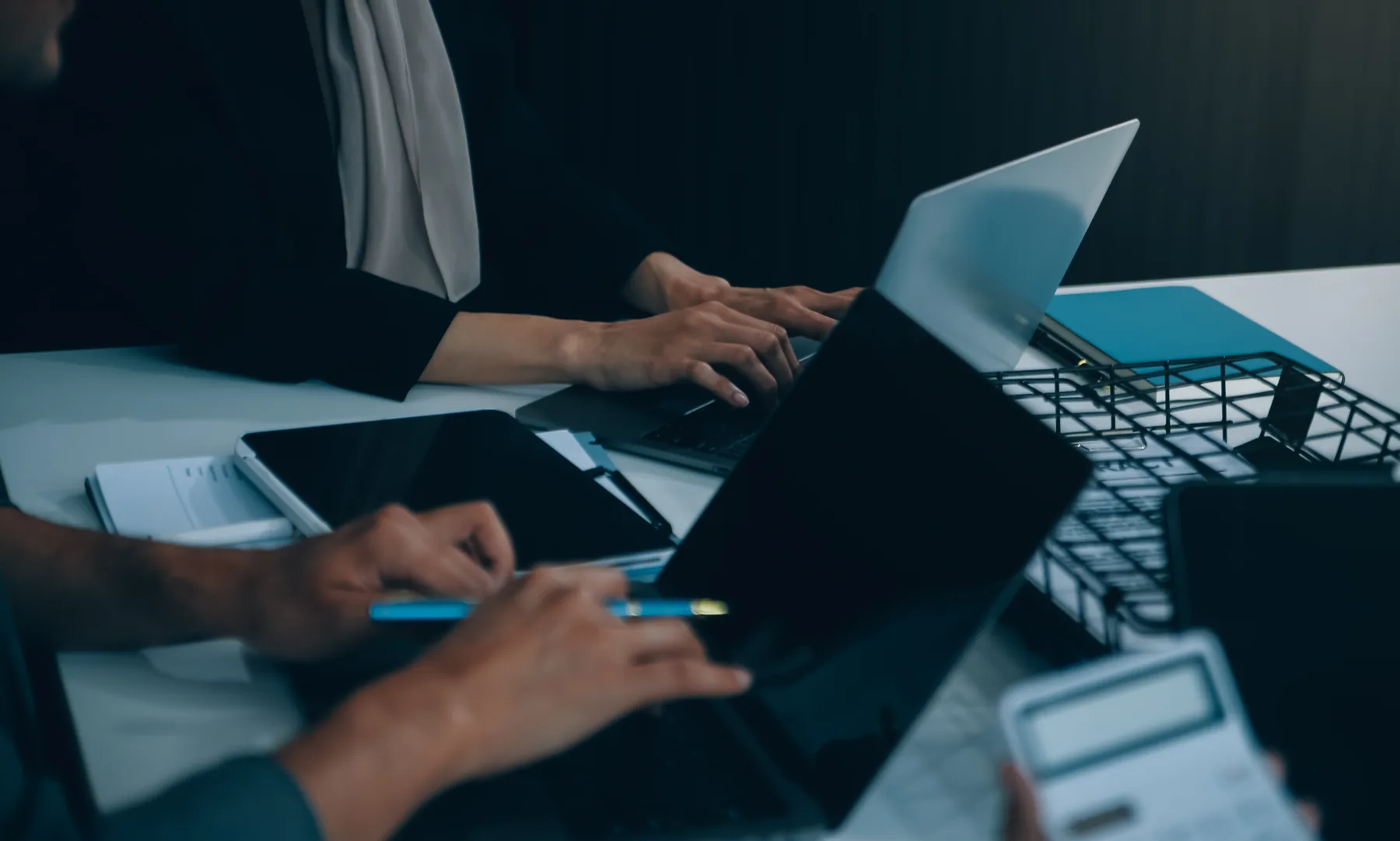 Business team working together with connected laptops and tablets