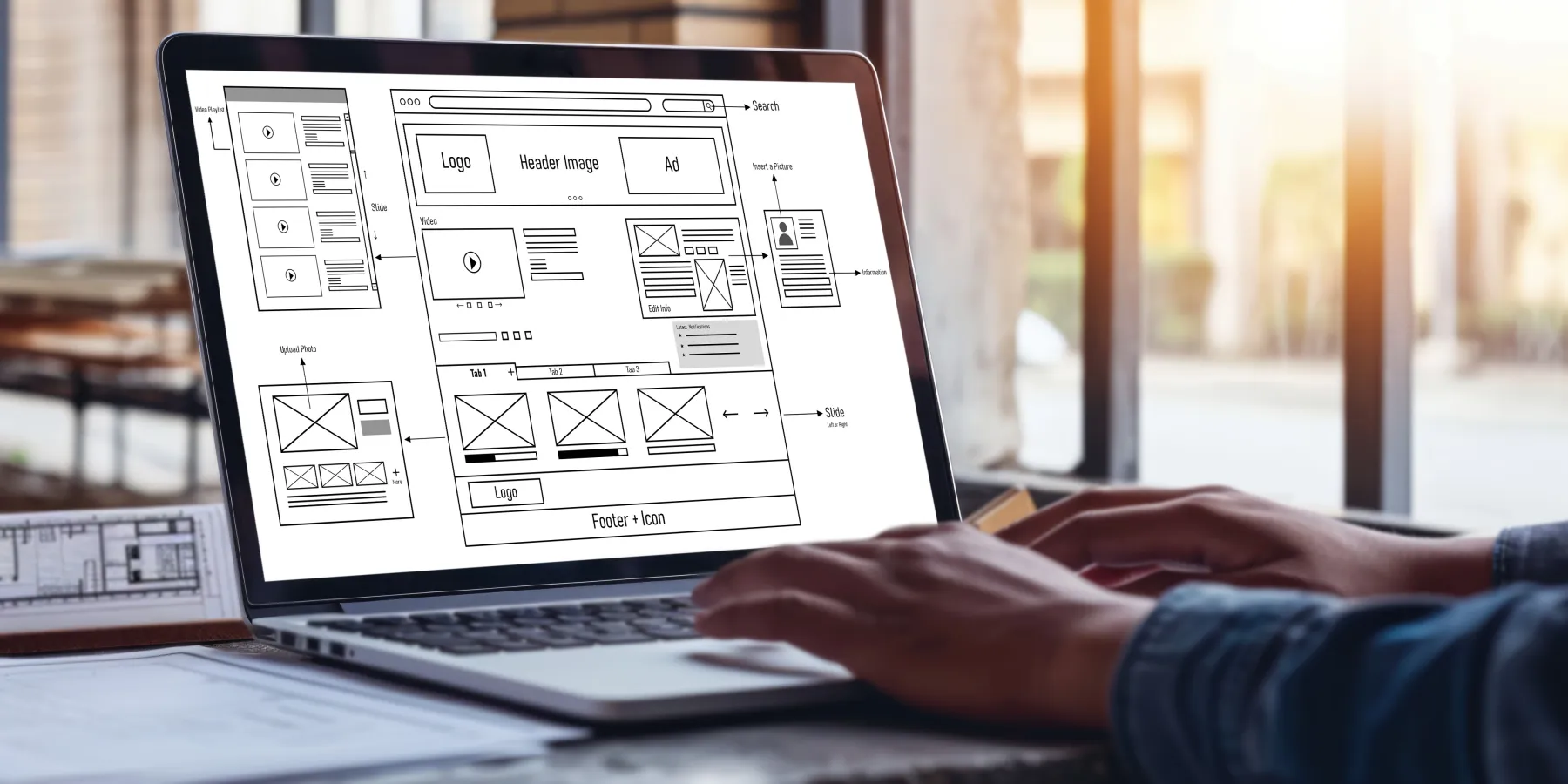 A website wireframe being reviewed on a laptop before development begins