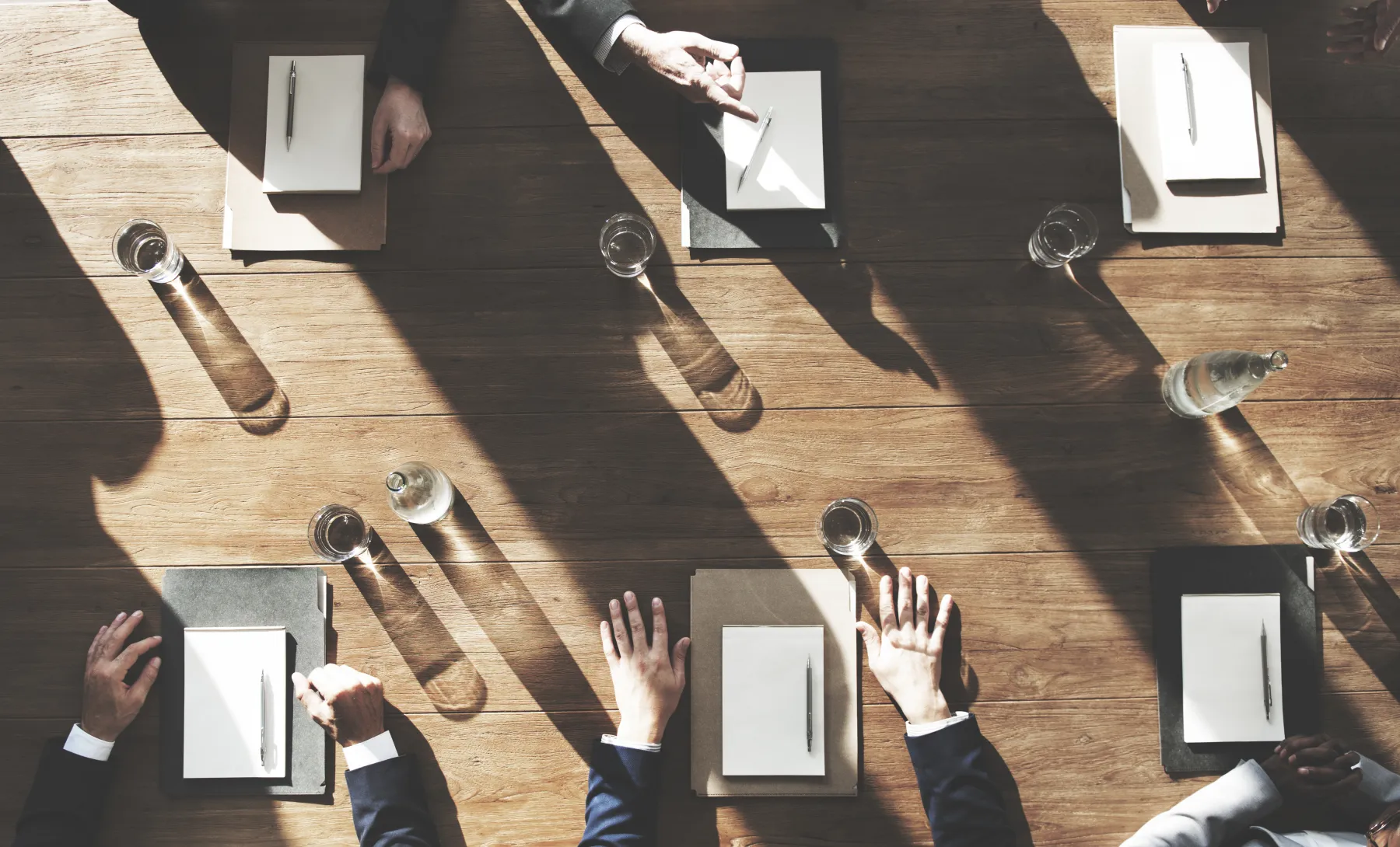 A business team collaborating around a shared meeting table