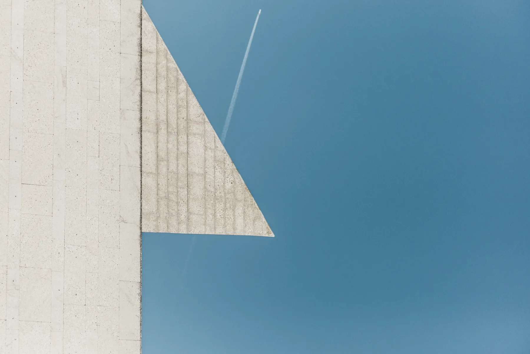 Architectural lines framing an open blue sky